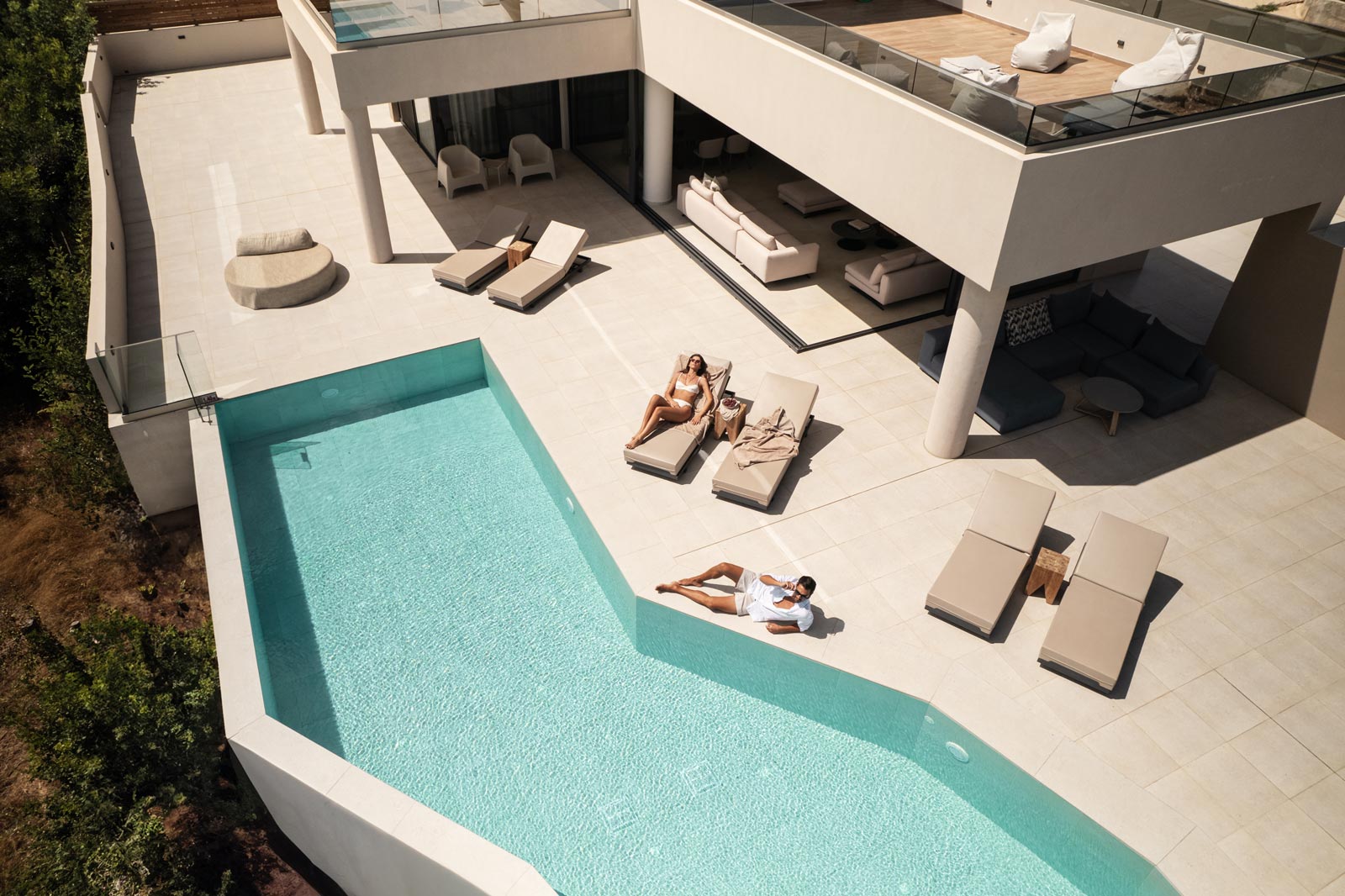 A MAN AND A WOMAN RELAXING AT POOL AREA