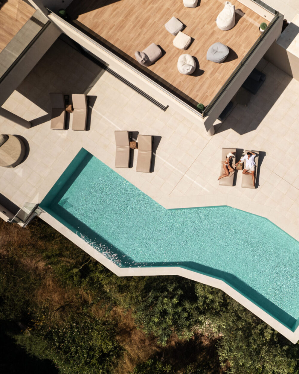 A MAN AND A WOMAN RELAXING AT POOL AREA